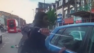 The moment a furious cyclist armed with huge zombie knife smashes car window  ITV News [upl. by Enaerb]